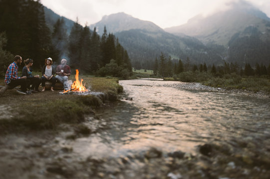 Friends sitting around a campfire