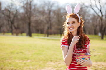 Portrait of red head woman wearing bunny ears