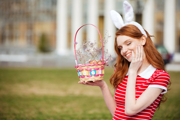 Portrait of a cute red head girl in bunny ears