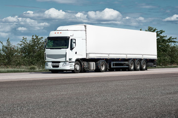 Fototapeta na wymiar Truck on road, blue sky, cargo transportation concept