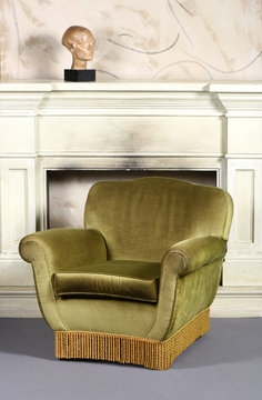 Retro Green Velvet Arm Chair in front of Fireplace