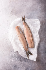 Freshly salted herring on gray background with copy space. Traditional Dutch delicacy. Retro style...