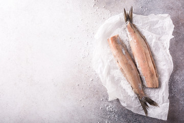 Freshly salted herring on gray background with copy space. Traditional Dutch delicacy. Retro style...