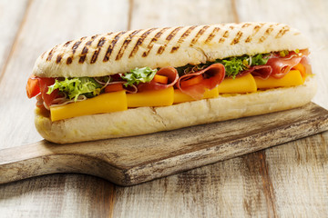 Traditional Italian sandwich with ham and cheese served warm.