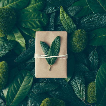 Creative layout made of green leaves with diy gift box. Flat lay. Nature concept