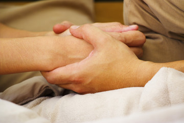 Man is massaging woman's hand