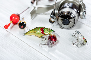 Fishing accessories on a wooden background. © Alex Ishchenko