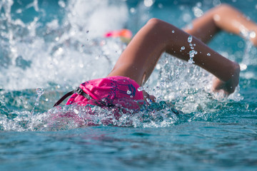 Young athlete kids training swimming sports in the pool