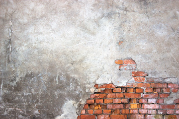 urban background of a brick wall with destroyed stucco