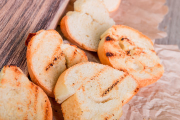 Grilled toast on wooden background. Top view. Rustic style.