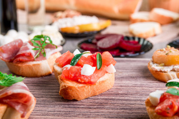 Set of bruschetta on wooden board. Ingredient for crostini. Italian food.