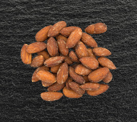 Hickory smoked almonds on a black counter top.