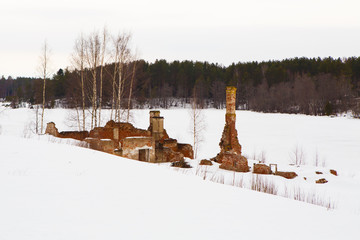 Remains of the ancient ruins of the residential house of red brick handmade. Old historic architecture is destroyed - the view of the ruins of the house in the winter.