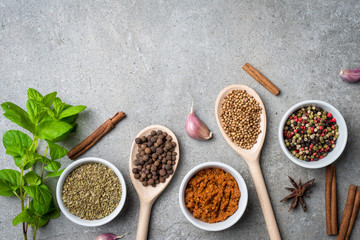 Fresh herbs and spices on gray stone table. Food background