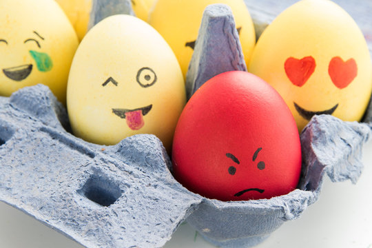 Happy easter: 4 emoji as easter eggs in egg carton - close up
