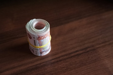 Russian rubles and American dollars. Money on a white background. Money on the texture of a tree....