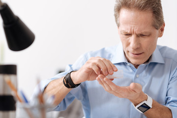 Serious man holding package with medicine