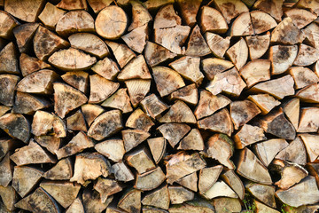 Pile or stack of natural fire wood logs texture background.