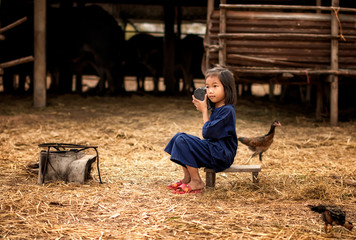 Asia children listen radio in countryside.