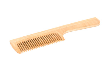 Wooden comb isolated on white background close-up