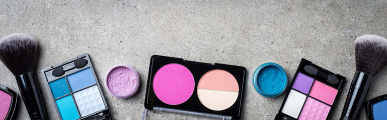 Makeup products on gray stone background
