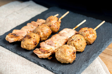 tasty kabobs with vegetables on a slate plate