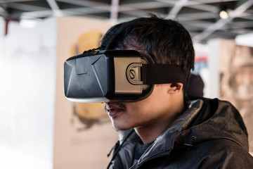 Fototapeta premium a man wearing VR virtual reality goggles
