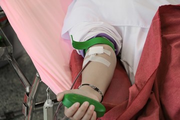 Blood donor at donation Close up with a bouncy ball holding in hand.