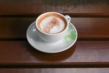 coffee cappuccino on the wood floor background