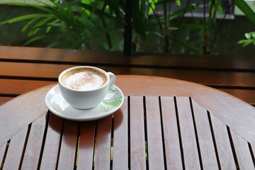 coffee cappuccino on the wood floor background