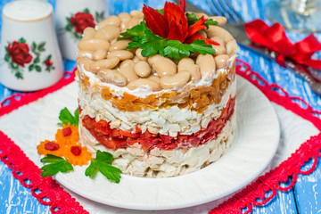 Multilayer festive salad with chicken, peppers and beans