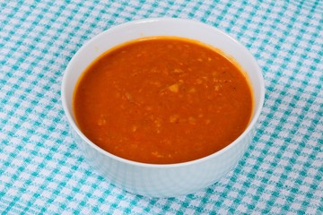 Spicy homemade vegetarian lentil, tomato vegetable soup, UK.