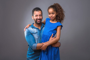 Young black father hugging his teenage daughter