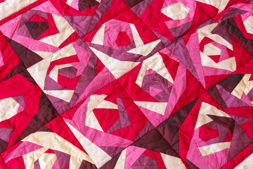 Part of color patchwork quilt with purple flowers pattern as background. Pink Scrappy blanket. Hobby Concept. Handmade. - obrazy, fototapety, plakaty