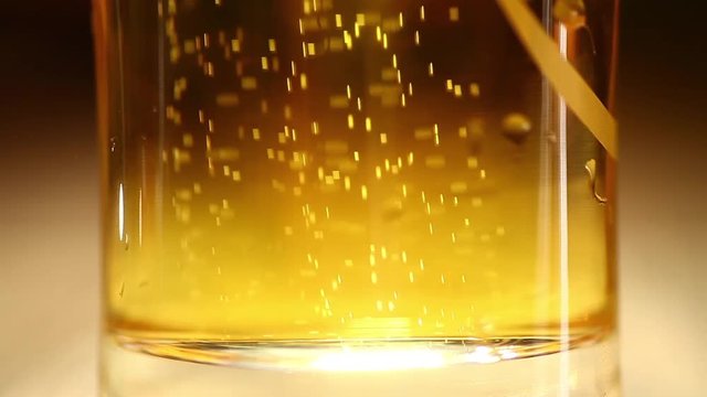 Close up footage of a beer glass on a counter in a pub or restaurant, with bubbles.