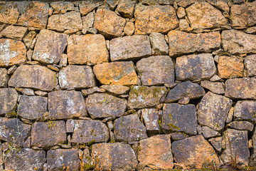 old weathered stone brown wall background in India, close up