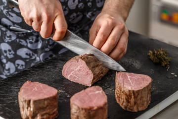 Chef is cutting meat