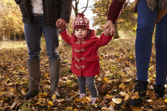 Close Up Of Young Girl On Autumn Walk With Parents