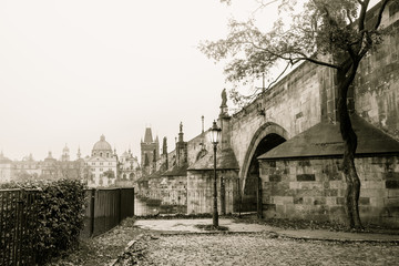 Misty morning in Prague near Charles bridge, old stylized photography.