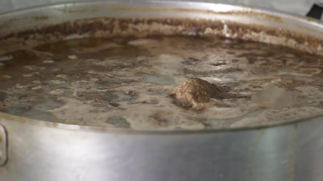 Meat boiling in pot, soup preparing