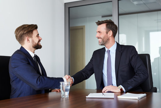 Two businessmen shaking hands after successful recruitment - job interview concept