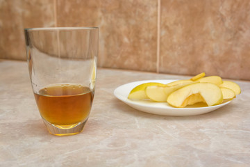 Glass of apple juice with sliced apple