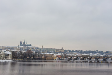 Fototapeta na wymiar St Vitus Cathedral and Charles Bridge in Prague covered in snow