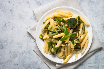 Italian vegetarian pasta penne with green vegetables.