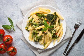 Italian vegetarian pasta penne with green vegetables.