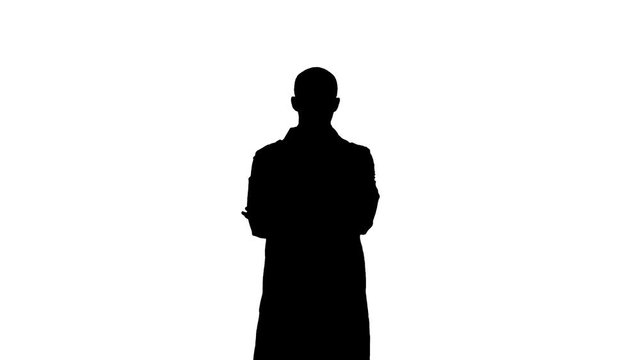 Silhouette Serious medical worker standing with his arms across his chest