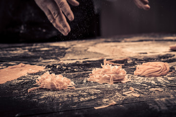 The chef makes fresh spaghetti from scratch.