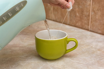 Teapot and cup of tea at home
