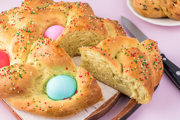 Baked homemade Easter bread with colorful eggs.