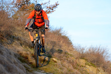 Obraz na płótnie Canvas Enduro Cyclist Riding the Mountain Bike on the Rocky Trail. Extreme Sport Concept. Space for Text.